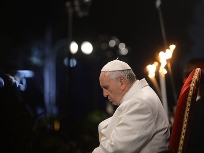 Pope Francis prays during the Way of the Cross torchlight procession at the Colosseum on Good Friday on April 3, 2015 in Rome. Christians around the world are marking the Holy Week, commemorating the crucifixion of Jesus Christ, leading up to his resurrection on Easter. AFP PHOTO / FILIPPO MONTEFORTE …