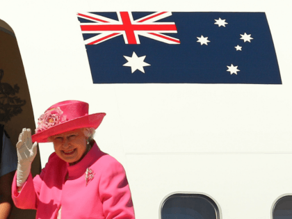 Queen Elizabeth II waves as she boards her flight at Melbourne Airport on October 26, 2011