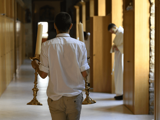 Seminarians from the Saint Martin community prepare an ordination Mass at Notre Dame de l'épine basilica in Evron, on June 24, 2017. The Saint Martin Community based in the biggest seminar in France provides priests and secular deacons living their apostolate together in increasingly numerous dioceses. / AFP PHOTO / …