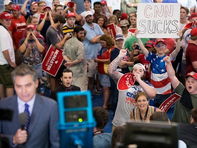 WEST COLUMBIA, SC - JUNE 25: People shout behind CNN reporter Jim Acosta before a campaign rally for South Carolina Governor Henry McMaster featuring President Donald Trump at Airport High School June 25, 2018 in West Columbia, South Carolina. (Photo by Sean Rayford/Getty Images)