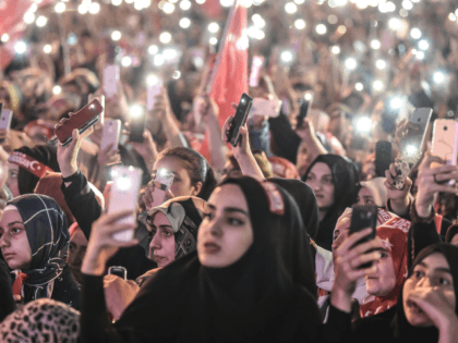 People lit lights of their mobile phones as they read the names of people killed during the July 15, 2016 coup attempt, while standing near the 'July 15 Martyrs Bridge' (Bosphorus Bridge) in Istanbul on July 15, 2018. - Turkey on commemorated the second anniversary of a bloody coup attempt …