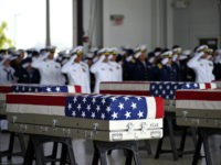 Flag draped transfer cases with the remains of American soldiers repatriated from North Korea are seen during a repatriation ceremony after arriving to Joint Base Pearl Harbor-Hickam, Honolulu, Hawaii, on August 1, 2018. - Sixty-five years after the Korean War ended, the remains of dozens of American soldiers killed during …