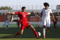 Palestine's Tamer Syam (L) and Iraq's Mazen Fyad (R) go in for a challenge during a friendly in the town of Al-Ram near Jerusalem in the occupied West Bank