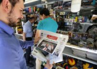 A man takes a glance at a newspaper with a picture of US president Donald Trump on the front page, in the capital Tehran on July 31, 2018