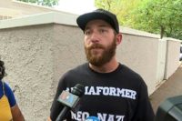 Jason Downard wore a black T-shirt with the words "I am a former neo-Nazi, ask me questions" printed across it