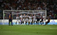 Wall game: Lionel Messi tries for goal from a free-kick
