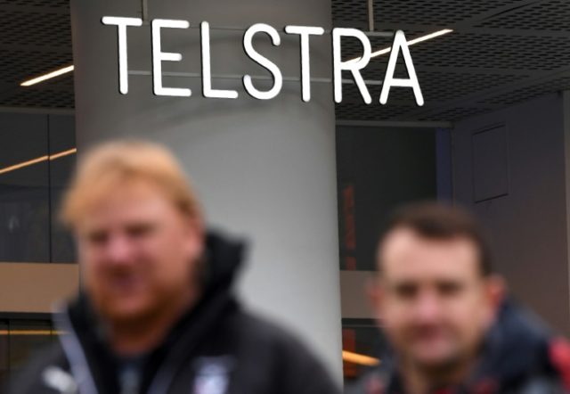 Australia telecom giant Telstra flags tough times as profit slides