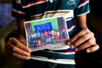 Young Rohingya refugee Mohammad Ayaz shares a creased family photo photograph, grainy and faded -- one of the few possessions he managed to keep hold of after fleeing Myanmar