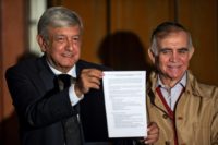 President-elect Andres Manuel Lopez Obrador shows a technical report on Mexico City's controversial new airport - already under construction - as he announces a referendum on whether to proceed with the project or cancel it