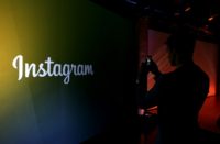 MENLO PARK, CA : An attendee takes a photo of the instagram logo during a press event at Facebook headquarters on June 20, 2013 in Menlo Park, California. Instagram is out to undercut duplicity by offering authenticated accounts