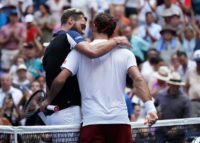 Old pals act: Roger Federer and Benoit Paire embrace