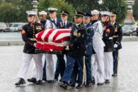 A military honor guard team carries the flag-draped casket of the late US Senator John McCain, Republican of Arizona, at the US Capitol in Washington