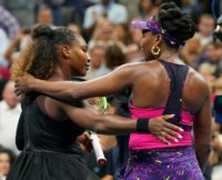 Embrace: Serena and Venus Venus Williams after their match on Friday