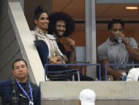 Former NFL players Colin Kaepernick (center) and Eric Reid (right) attends US Open match between Serena and Venus Williams on Friday.