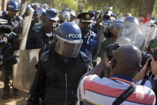 APTOPIX Zimbabwe Elections Riot police enter the Bronte hotel, where a press conference by opposition leader Nelson Chamisa was scheduled to take place, in Harare, Zimbabwe, Friday Aug. 3, 2018. Hours after President Emmerson Mnangagwa was declared the winner of a tight election, riot police disrupted a press conference where opposition leader Nelson Chamisa was about to respond to the election results. (AP Photo/Jerome Delay) The Associated Press