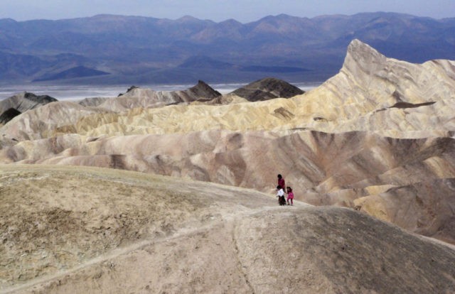 Death Valley Hottest Month In this April 11, 2010 file photo, tourists walk along a ridge at Death Valley National Park, Calif. Preliminary data show that Death Valley set the world record for hottest month in July, 2018. National Weather Service meteorologist Todd Lericos says the month's average temperature at Furnace Creek in Death Valley was 108.1 degrees Fahrenheit (42.28 Celsius). That eclipses the previous record, set in Death Valley during July 2017 when the average was 107.4 degrees F (41.89 C). (AP Photo/Brian Melley, File) The Associated Press