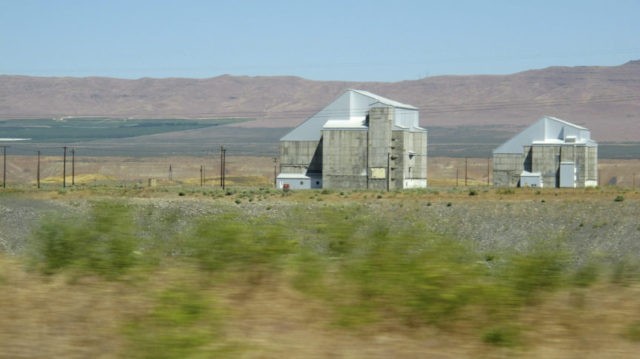 Hanford Reactors File This June 13, 2017 file photo shows two decommissioned plutonium producing reactors on the Hanford Nuclear Reservation near Richland, Wash. The land where the federal government created some of the plutonium for nuclear weapons will be so cleaned of radiation and other pollution that it could be used for homes in the future. The plan announced Monday, July 30, 2018, would spend $200 million to clean up 7.8 square miles in a portion of Hanford called the 100 Area D and H areas. (AP Photo/Nicholas K. Geranios, File) The Associated Press