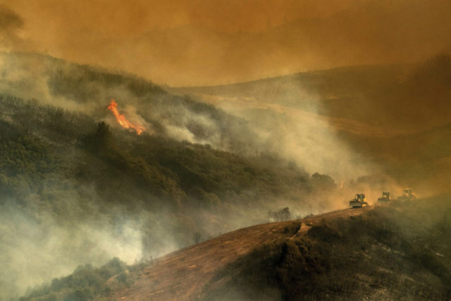 California Wildfires Record In this Tuesday, July 31, 2018, file photo, bulldozer operators and their machines build containment lines while battling the River Fire in Lakeport, Calif. Authorities say a rapidly expanding Northern California wildfire burning over an area the size of Los Angeles has become the state's largest blaze in recorded history. It's the second year in a row that California has recorded the state's largest wildfire. (AP Photo/Noah Berger, File) The Associated Press