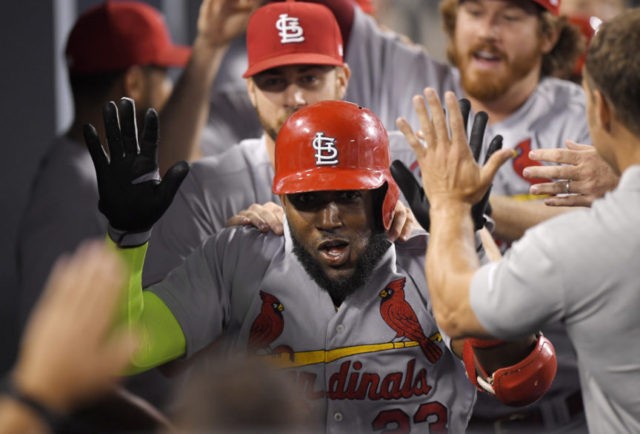 APTOPIX Cardinals Dodgers Baseball Marcell Ozuna St. Louis Cardinals' Marcell Ozuna is congratulated by teammates in the dugout after hitting a two run home run during the seventh inning of a baseball game against the Los Angeles Dodgers, Tuesday, Aug. 21, 2018, in Los Angeles. (AP Photo/Mark J. Terrill) The Associated Press