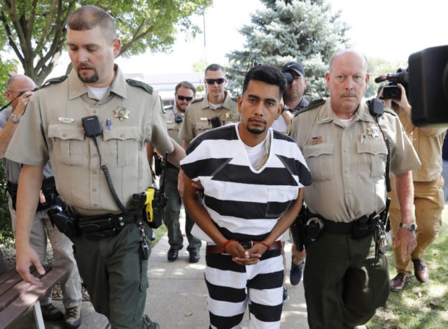 Cristhian Bahena Rivera is escorted into the Poweshiek County Courthouse for his initial court appearance, Wednesday, Aug. 22, 2018, in Montezuma, Iowa. Rivera is charged with first-degree murder in the death of Mollie Tibbetts, who disappeared July 18 from Brooklyn, Iowa. (AP Photo/Charlie Neibergall)