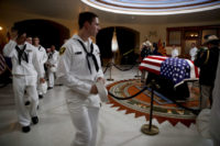 The Latest: Several in line to honor McCain overcome by heat