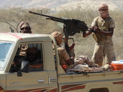 Yemeni fighters loyal to the government backed by the Saudi-led coalition fighting in the country ride in the back of a pickup truck with mounted heavy machine gun while closing in on a suspected location of an Al-Qaeda in the Arabian Peninsula (AQAP) leader during their the offensive in the …