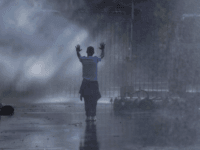 An opposition MDC party supporters hold his hands up after being sprayed with a water canon and in clouds of teargas on a street in Harare during clashes with police An opposition MDC party supporters hold his hands up after being sprayed with a water canon and in clouds of teargas on a street in Harare during clashes with police Wednesday, Aug. 1, 2018. Hundreds of angry opposition supporters outside Zimbabwe's electoral commission were met by riot police firing tear …
