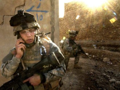 U.S. Army Pfc. Thaddeus Schoenemann, from 1st Brigade, 1st Armored Division, relays his position during a combat patrol in Tall Afar, Iraq, April 8, 2006. DoD photo by Staff Sgt. Aaron Allmon, U.S. Air Force. (Released)