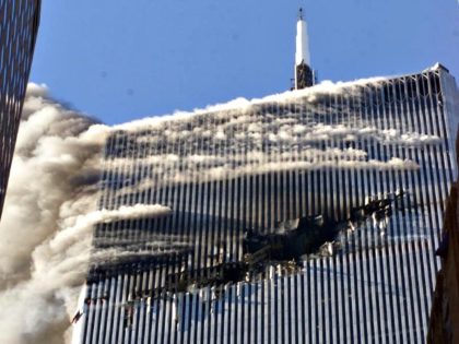 Smoke pours from a gaping hole and the upper floors of the World Trade Center's North Tower, shortly after hijackers crashed American Airlines Flight 11 into the building on September 11, 2001 in New York City. #