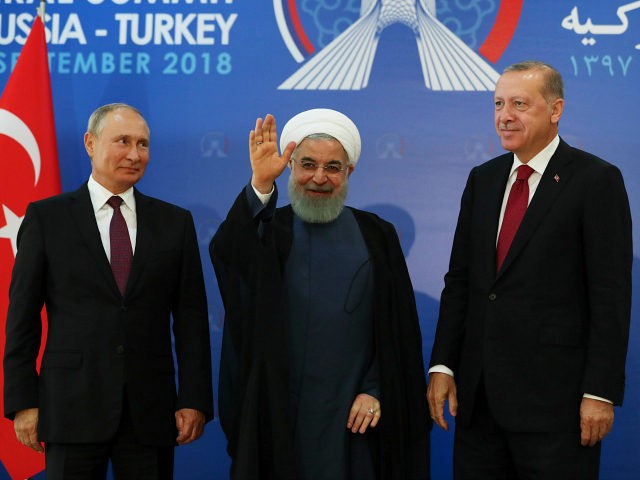 Iran's President Hassan Rouhani, centre, flanked by Russia's President Vladimir Putin, lef