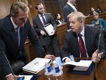Sen. Jeff Flake, R-Ariz., left, speaks with Sen. Lindsey Graham, R-S.C., as the Senate Jud