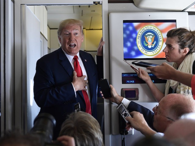 President Donald Trump talks to reporters while in flight from Billings, Mont., to Fargo,