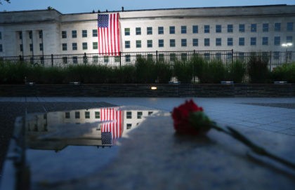 A U.S. flag is unfurled at sunrise on Tuesday, Sept. 11, 2018, at the Pentagon on the 17th