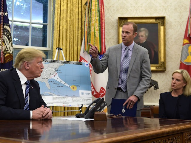 President Donald Trump, left, listens as FEMA Administrator Brock Long, center, talks abou