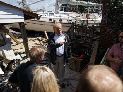 President Donald Trump visits a neighborhood impacted by Hurricane Florence, Wednesday, Sept. 19, 2018, in New Bern, N.C. (AP Photo/Evan Vucci)