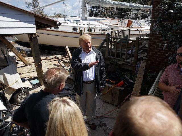 President Donald Trump visits a neighborhood impacted by Hurricane Florence, Wednesday, Se