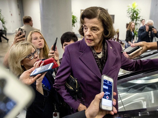 Sen. Dianne Feinstein, D-Calif., speaks to reporters as she walks through the Senate Subway as she arrives for a policy luncheon on Capitol Hill in Washington, Tuesday, Sept. 25, 2018. (AP Photo/Andrew Harnik)
