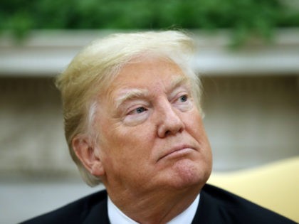 President Donald Trump listens to a reporter's question during a meeting with Chilean