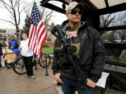 Marty Combs openly carries his AR-15 pistol at a pro gun rally on April 21, 2018 in Boulde