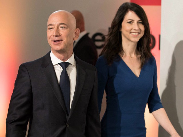 Amazon CEO Jeff Bezos and his wife MacKenzie Bezos arrive at the headquarters of publisher