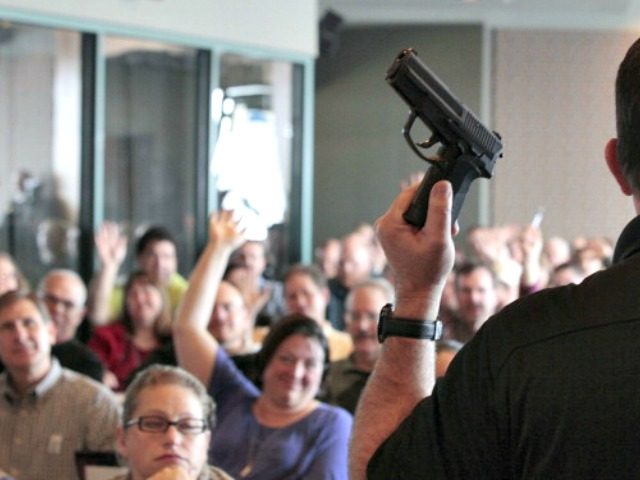 WEST VALLEY CITY, UT - DECEMBER 27: Firearm instructor Clark Aposhian holds a handgun up as he teaches a concealed-weapons training class to 200 Utah teachers on December 27, 2012 in West Valley City, Utah. The Utah Shooting Sports Council said it would waive its $50 fee for concealed-weapons training …
