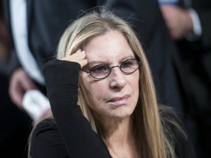 Musical artist Barbra Streisand waits to listen to US President Barack Obama speak during