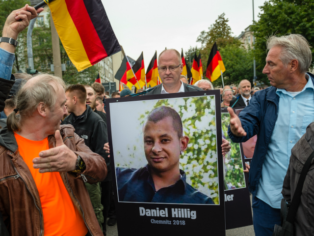 People take part in a march of silence organized by the right-wing Alternative for Germany (AfD) political party and carry German flags and portraits of supposed victims of refugee violence on September 1, 2018 in Chemnitz, Germany. (Jens Schlueter/Getty Images)