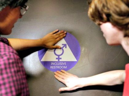 Students placed a sticker on the door of a new gender-neutral bathroom at Nathan Hale High