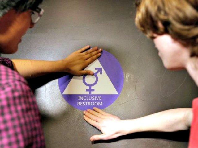 Students placed a sticker on the door of a new gender-neutral bathroom at Nathan Hale High School in Seattle on Tuesday.