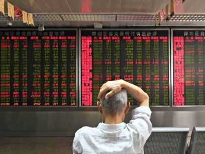 A man checks stock price movements at a securities company in Beijing on July 4, 2018.