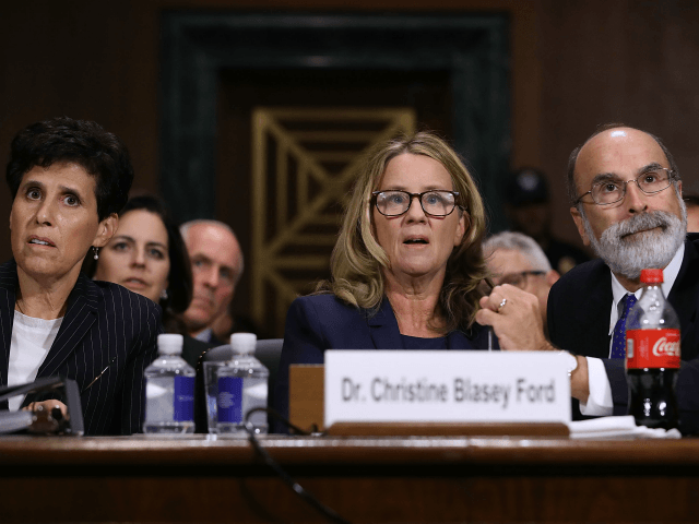 Christine Blasey Ford (C) is flanked by her attorneys Debra Katz (L) and Michael Bromwich