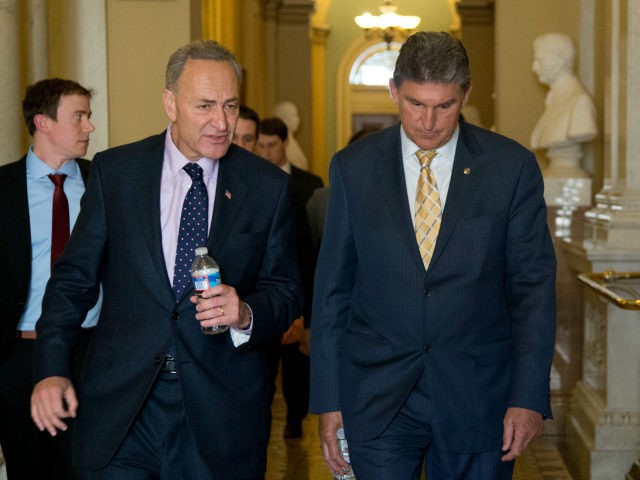 Sens. Chuck Schumer, D-N.Y. left, and Joe Manchin, D-W.Va., walk in the Capitol following