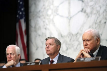 Sen. John Cornyn, R-Texas, left, and Sen. Orrin Hatch, R-Utah,, right, listen as Sen. Lindsey Graham, R-S.C., as President Donald Trump's Supreme Court nominee Brett Kavanaugh answers a question as he testifies before the Senate Judiciary Committee on Capitol Hill in Washington, Thursday, Sept. 6, 2018, for the third day …