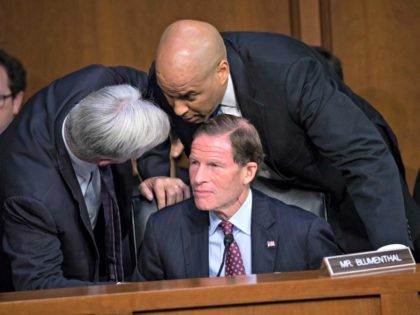 Sen. Sheldon Whitehouse, D-R.I., left, and Sen. Cory Booker, D-N.J., confer with Sen. Richard Blumenthal, D-Conn., seated, as Democrats on the Senate Judiciary Committee appeal to Chairman Chuck Grassley, R-Iowa, to delay the confirmation hearing of President Donald Trump's Supreme Court nominee, Brett Kavanaugh, on Capitol Hill in Washington, Tuesday, …